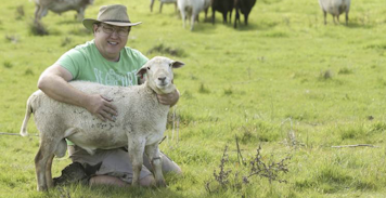 Photo of Cyan on the farm with Roger, one of our harlequin sheep